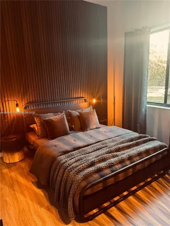 a bedroom with a bed and window