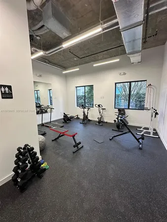 a living room with furniture and gym equipment