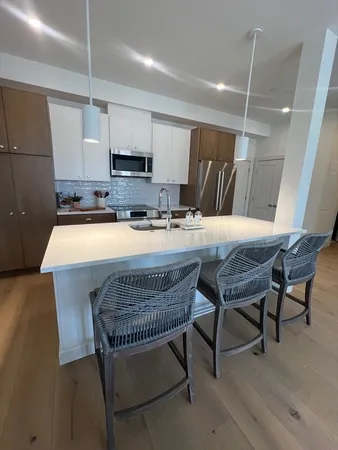 a kitchen with a table chairs sink and cabinets