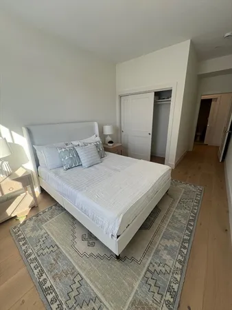 a large bed sitting in a bedroom next to a lamp