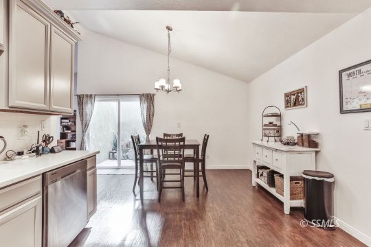 1023 North Norma Street Ridgecrest, CA 93555 - Photo 16 of 32 a view of a dining room and livingroom with furniture wooden floor a chandelier