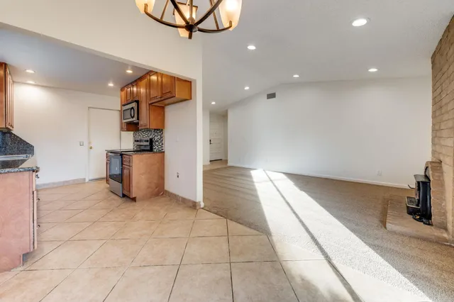 a view of a kitchen with a sink and a refrigerator