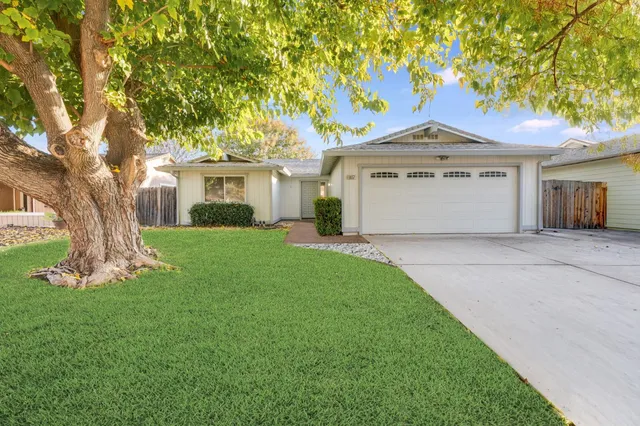 a front view of house with yard and green space