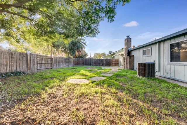 a view of a house with backyard and sitting area
