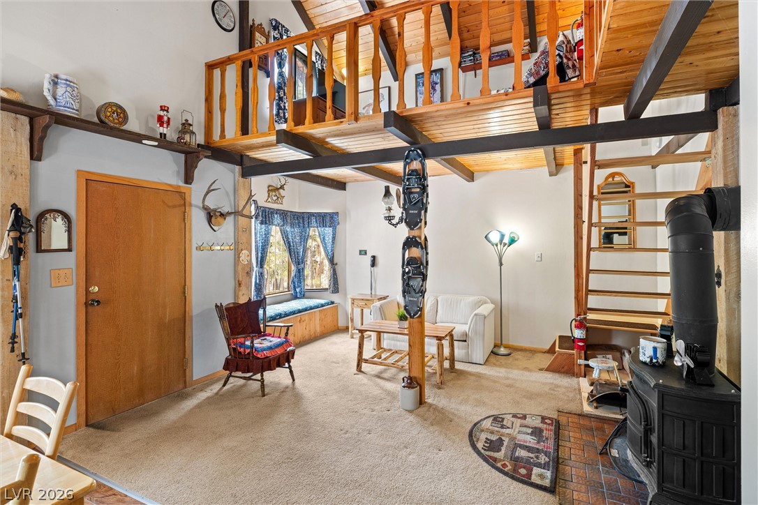 2146 Via Spes Nostra Street Mount Charleston, NV 89124 - Photo 20 of 33 A cozy, sun-filled living area boasts a rustic aesthetic with a charming window seat and an inviting loft above.