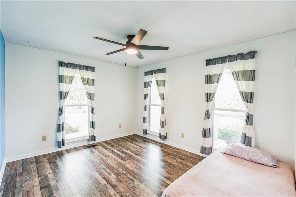 500 Coleman Mill Road Carrollton, GA 30116 - Photo 17 of 83 a view of empty room with wooden floor and fan