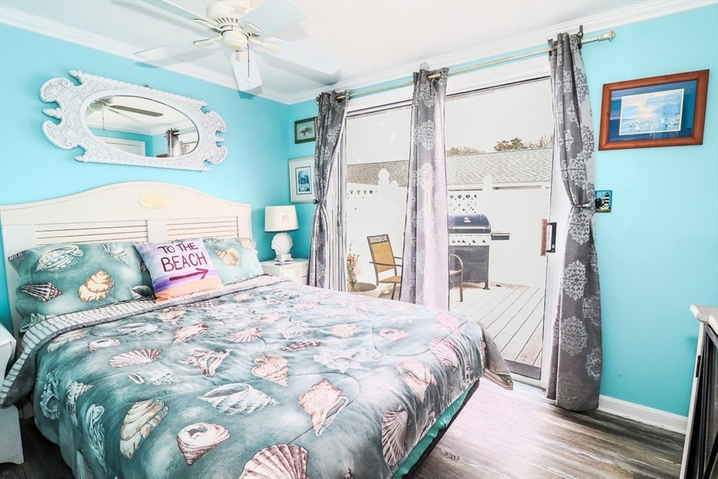 a bedroom with a bed mirror and a window