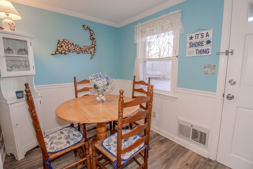 433 Lower County Road, Unit 25 Dennis, MA 02639 - Photo 11 of 32 a view of a dining room with furniture window and wooden floor