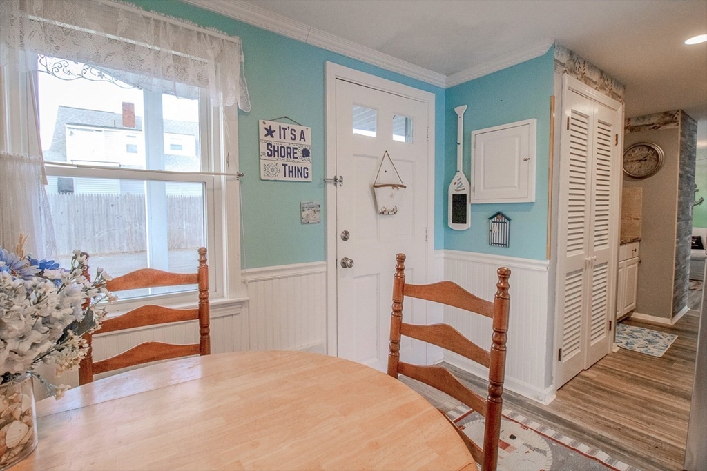 433 Lower County Road, Unit 25 Dennis, MA 02639 - Photo 12 of 32 a view of a bedroom with wooden floor and windows