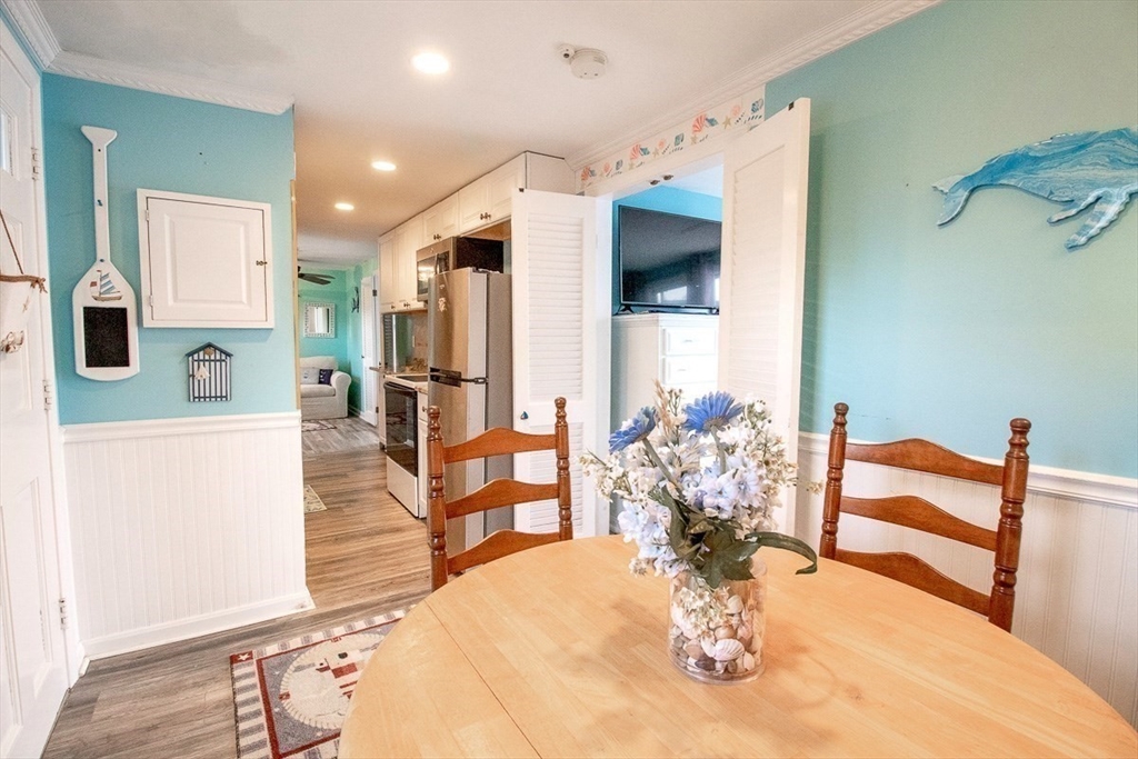 433 Lower County Road, Unit 25 Dennis, MA 02639 - Photo 13 of 32 a kitchen with stainless steel appliances kitchen island granite countertop a refrigerator and a sink