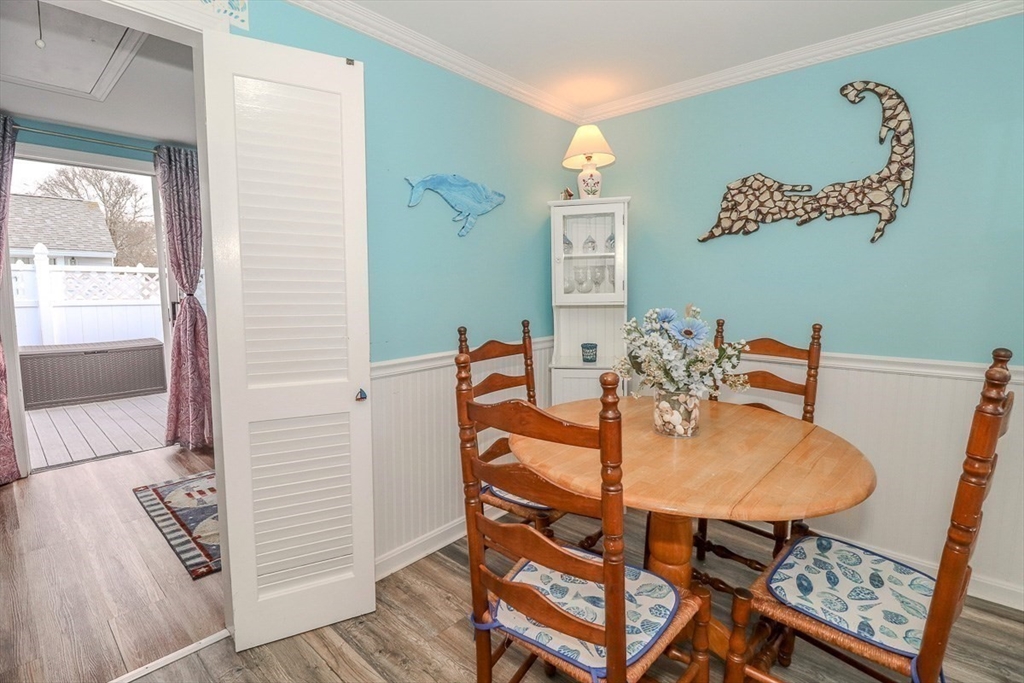 433 Lower County Road, Unit 25 Dennis, MA 02639 - Photo 14 of 32 a dining room with furniture and wooden floor