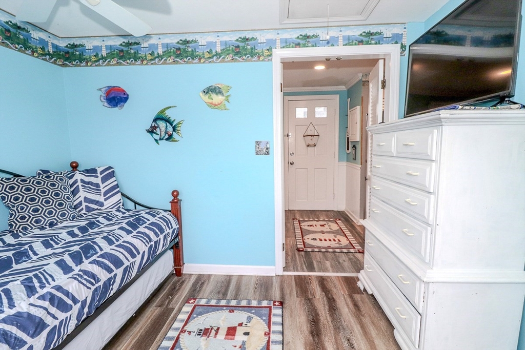 433 Lower County Road, Unit 25 Dennis, MA 02639 - Photo 17 of 32 a bedroom with a bed and flat screen tv
