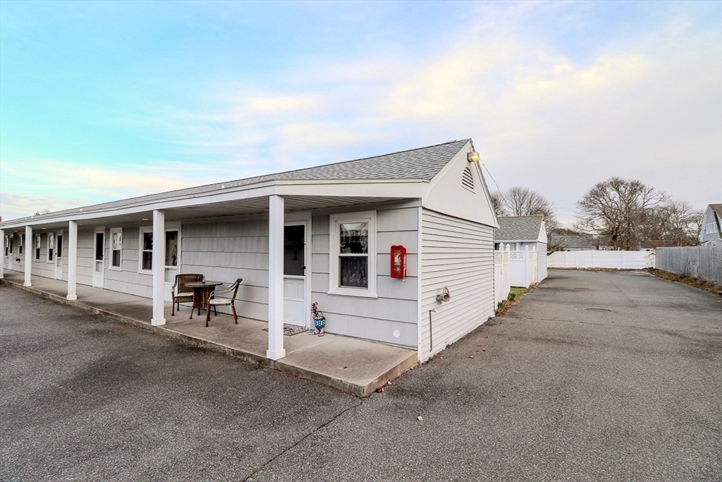 433 Lower County Road, Unit 25 Dennis, MA 02639 - Photo 25 of 32 a view of a white house with large windows