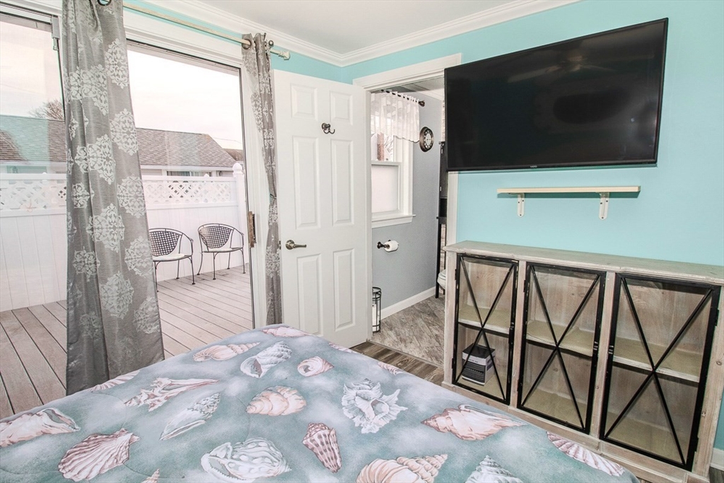 433 Lower County Road, Unit 25 Dennis, MA 02639 - Photo 3 of 32 a view of a livingroom with wooden floor and a flat screen tv