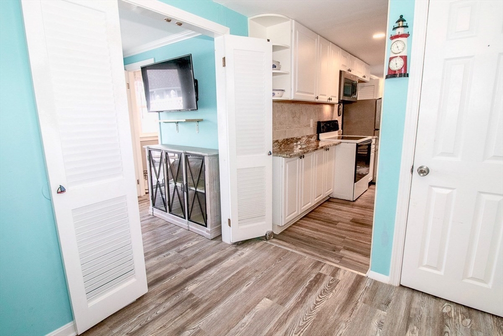 433 Lower County Road, Unit 25 Dennis, MA 02639 - Photo 6 of 32 a view of a kitchen from the hallway