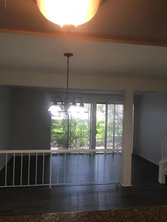 a view of wooden floor and window in a room