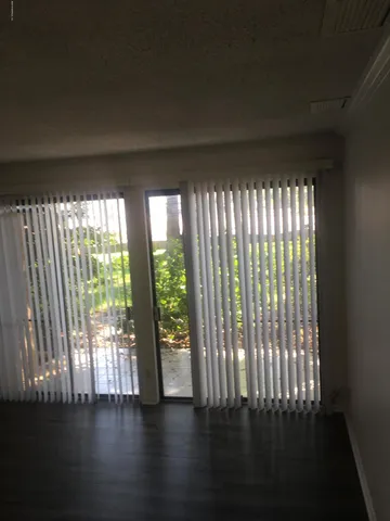 a view of wooden floor and windows in a room