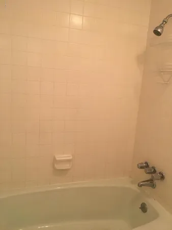 a bathroom with a white bath tub and a roof window