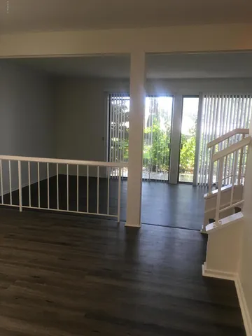 a view of wooden floor and windows