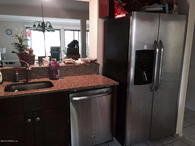 a kitchen with a sink and refrigerator