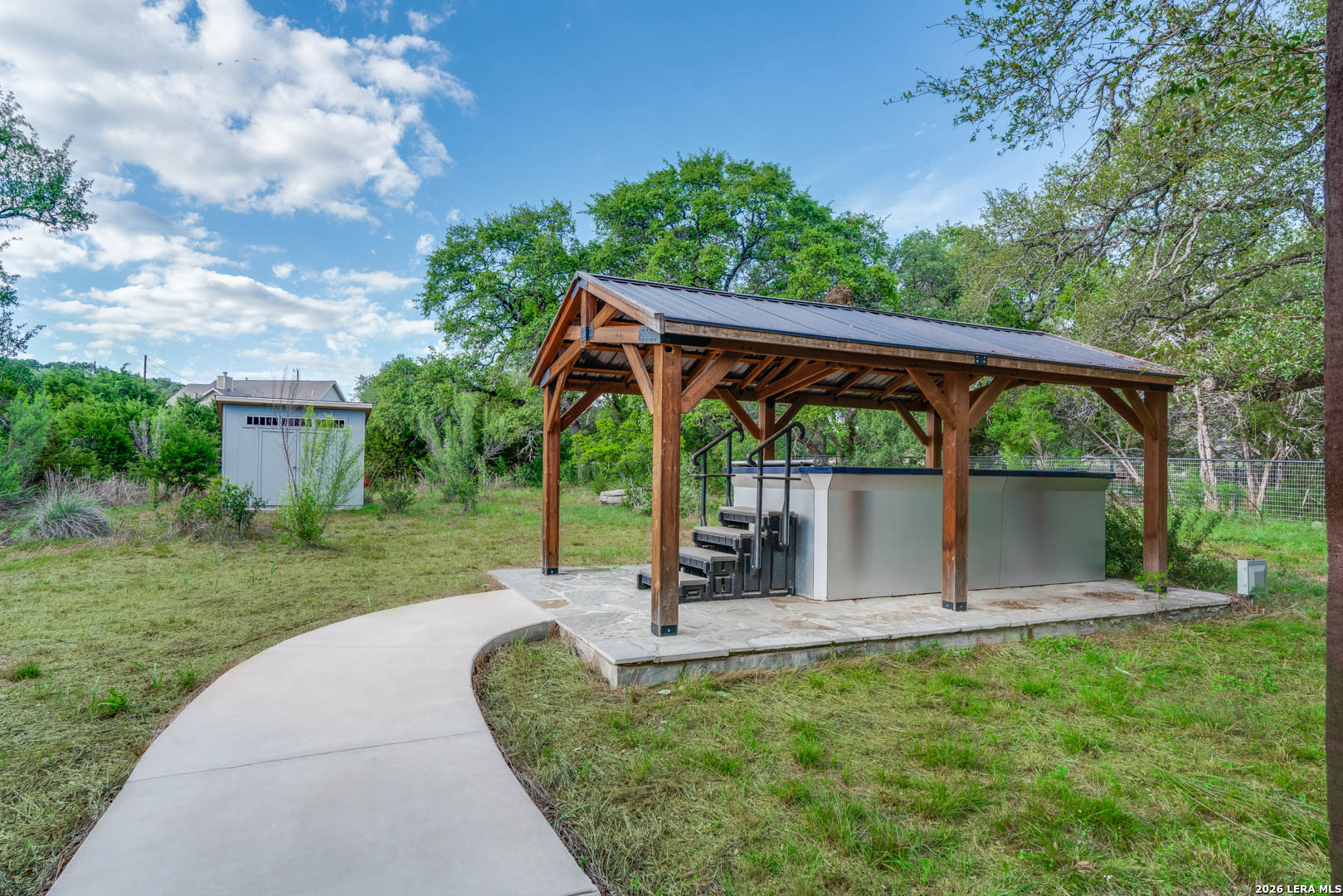 316 Prairie Tea Lane Spring Branch, TX 78070 - Photo 32 of 38 a view of a backyard with a garden and entertaining space