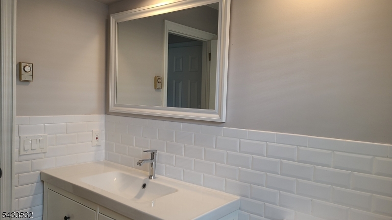 16 Ocean Street Millburn, NJ 07041 - Photo 13 of 26 a bathroom with a sink and a mirror
