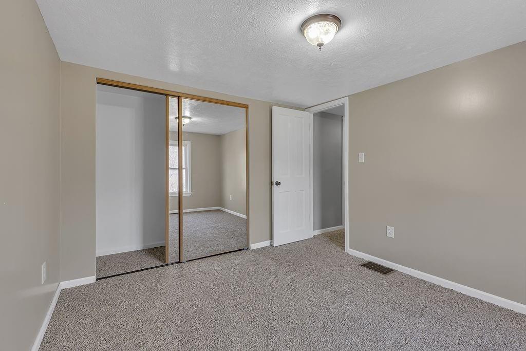 589 Pine Run Road Freedom, PA 15042 - Photo 25 of 29 an empty room with closet and sliding door