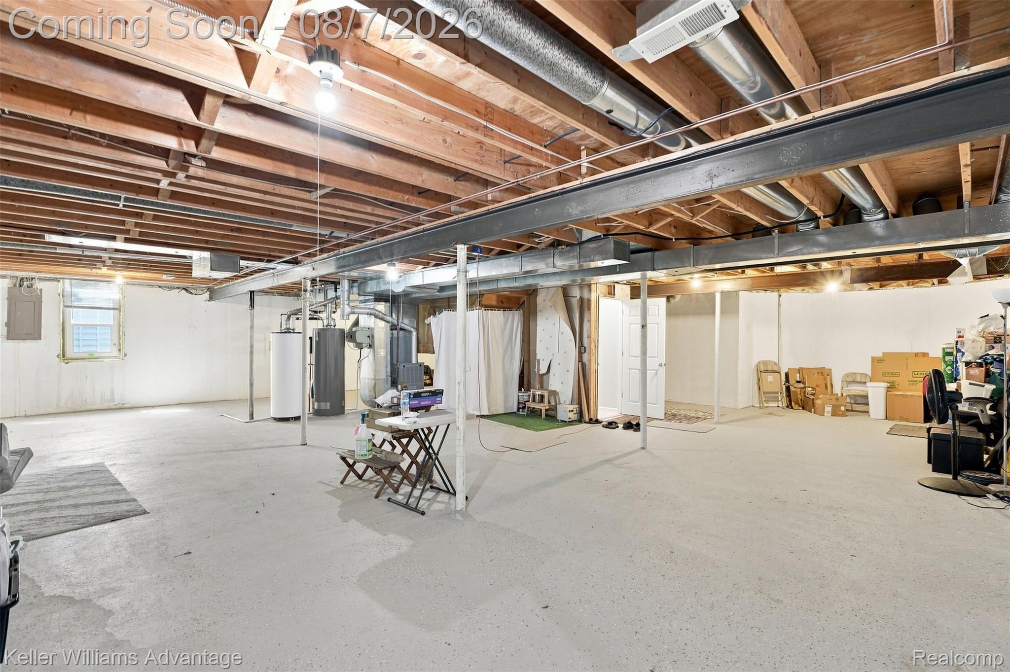 5325 Simpson Lake Road West Bloomfield, MI 48323 - Photo 30 of 43 Expansive unfinished basement featuring an exposed ceiling, concrete flooring, and visible structural beams
