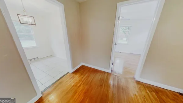 an empty room with wooden floor