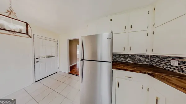 a white refrigerator freezer and a stove sitting inside of a kitchen