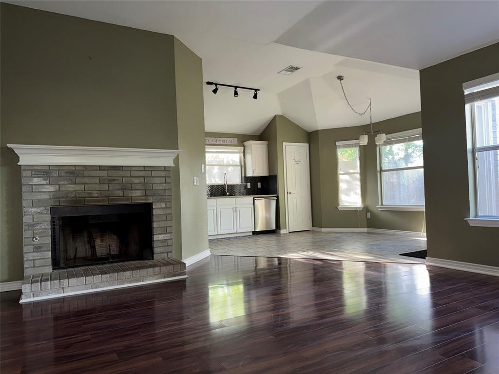 6241 Peach Tree Drive Midlothian, TX 76065 - Photo 3 of 19 Living area featuring a brick fireplace with a white mantel, wood-finish flooring, and a vaulted ceiling