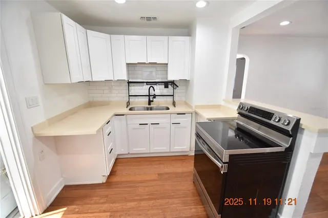 a kitchen with a sink stove and cabinets
