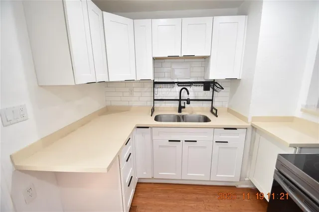 a kitchen with a sink and cabinets