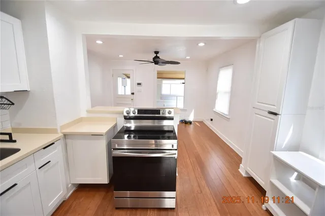 a kitchen with wooden floor and a stove top oven