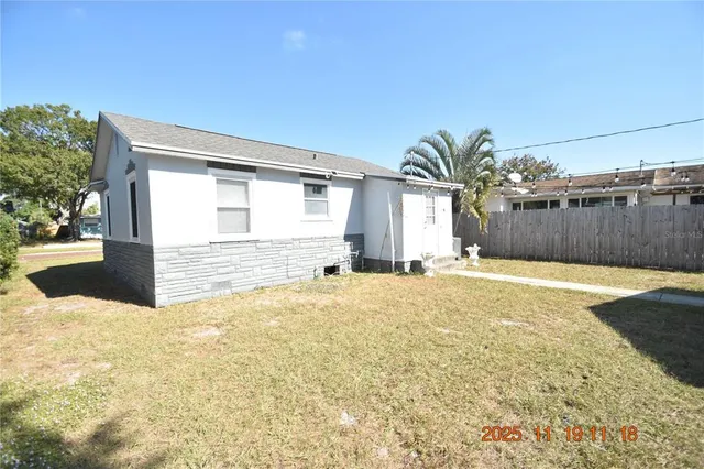 a swimming pool with outdoor seating and yard
