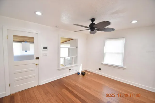 wooden floor in an empty room with a window