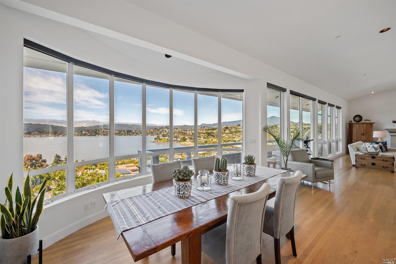 a living room with furniture and floor to ceiling windows