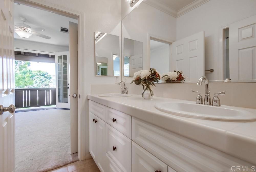 573 Cypress Hills Drive Encinitas, CA 92024 - Photo 45 of 75 a bathroom with a double vanity sink and a mirror