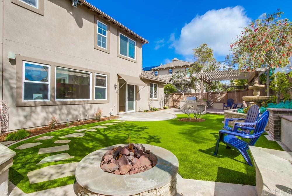 573 Cypress Hills Drive Encinitas, CA 92024 - Photo 60 of 75 a backyard of a house with table and chairs