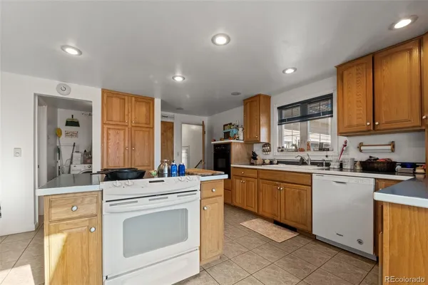 a kitchen with stainless steel appliances granite countertop a stove sink and cabinets