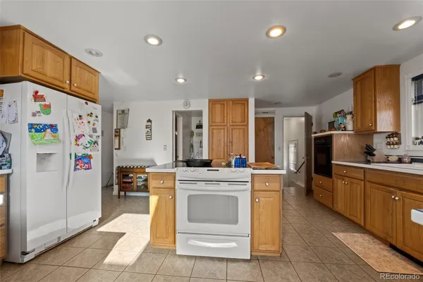 a kitchen with stainless steel appliances granite countertop a refrigerator and a stove top oven