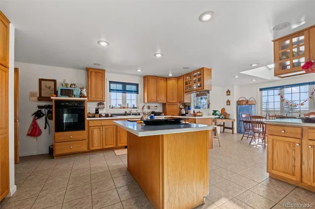 a kitchen with stainless steel appliances granite countertop a stove top oven a sink dishwasher and a refrigerator
