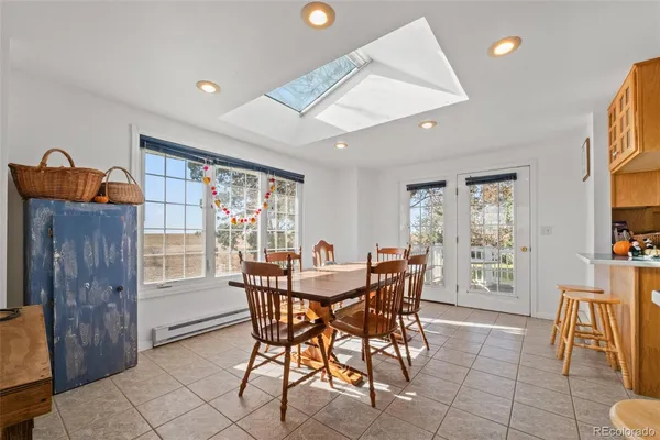 a view of a dining room with furniture and chandelier