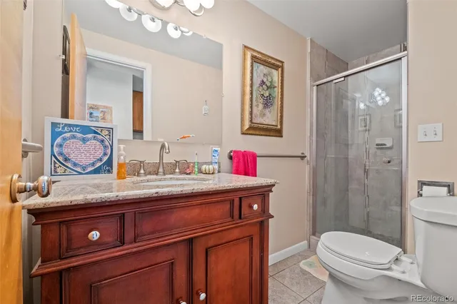 a bathroom with a bath tub sink mirror vanity and toilet