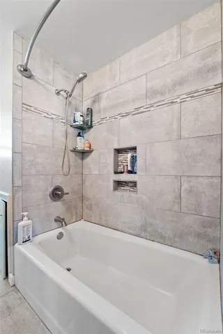 a bathroom with a bathtub and a shower