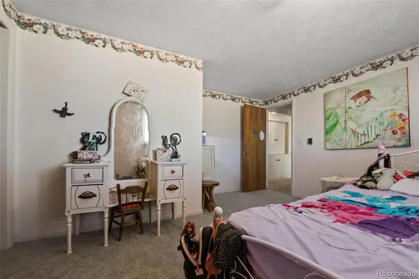 a bedroom with a bed a desk and chair