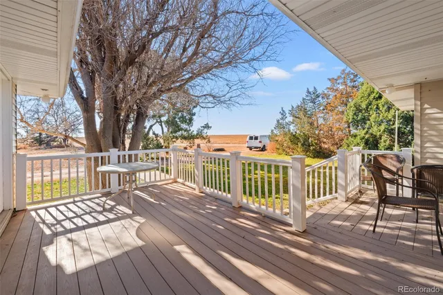 a view of a balcony with wooden floor