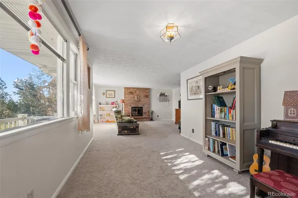 a living room with furniture and a book shelf