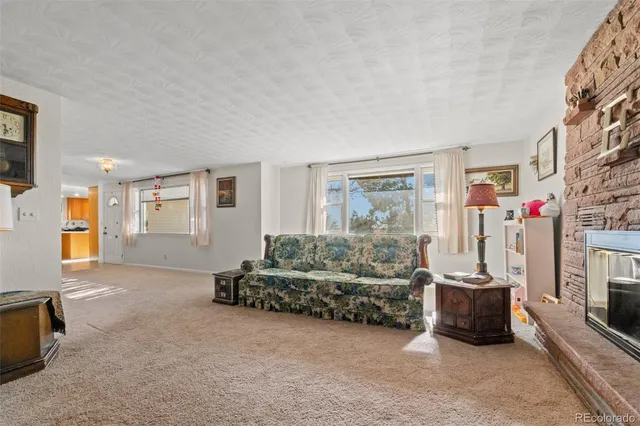 a living room with furniture a window and a flat screen tv