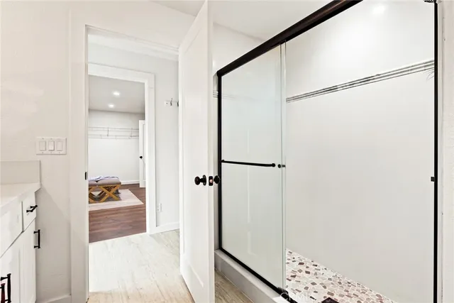 a walk in closet with a bathroom